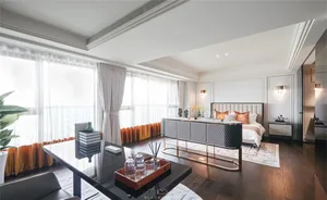 Modern living room featuring metallic furniture, large windows, and a comfortable seating area.
