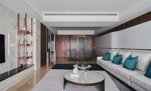 Modern minimalist living room with marble countertops and oak walls, featuring a comfortable seating arrangement and decorati