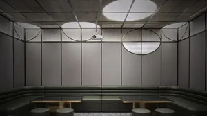 An industrial-style cafe with metal, leather, and glass materials, featuring modern seating and a sleek, minimalist design.