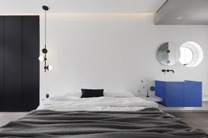 Modern bedroom featuring a minimalist design with metal accents.