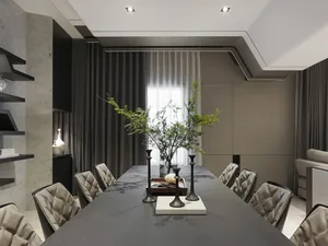 A minimalist dining room with concrete finishes, grey furniture, and a long dining table.