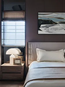 Modern bedroom with a fabric bed design featuring brown accents and a minimalist aesthetic.
