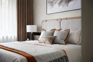 Modern bedroom with a bed featuring fabric and leather elements.