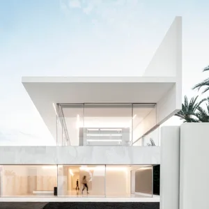 A modern house exterior with white marble materials and large glass windows.