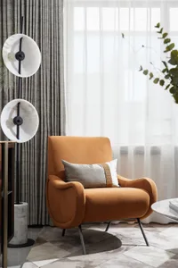 A modern living room with an orange armchair, marble floor lamp, and sheer curtains.