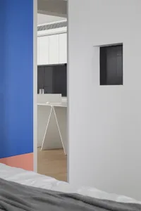 Modern minimalist kitchen with clean lines, white cabinets, and a triangle-shaped kitchen island.