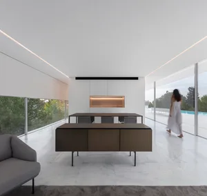 A modern minimalist dining room featuring a white marble floor and furniture.