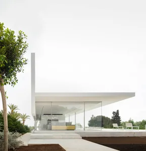 A contemporary residential exterior with large glass panels and a minimalist design.