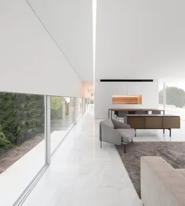 Modern residential kitchen with white marble countertops, white marble flooring, and minimalist design.