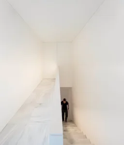 Modern interior space with marble flooring and walls.