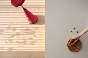 A modern interior scene featuring a red cone-shaped seat and a metallic disc