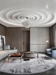 Modern living room featuring a white round ceiling with concentric circles, a large circular coffee table, and a long gray so