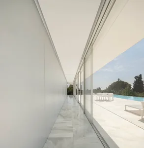 Modern white marble exterior with large glass windows.