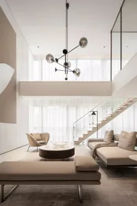 Modern minimalist living room with a glass staircase, beige seating, and a central coffee table.