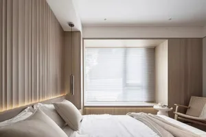 A minimalist bedroom featuring wood walls and a window with white blinds.