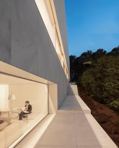 Modern residential building with concrete exterior and large windows