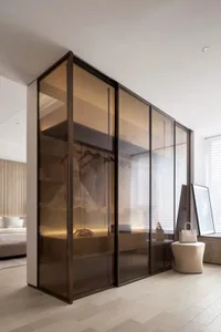 A modern closet with glass doors, showcasing elegant design and minimalist aesthetics.