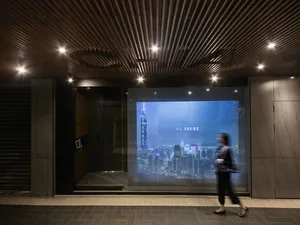 Digital display showing a cityscape at night with Taipei 101 tower illuminated.