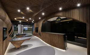 A modern, stylish bar reception desk with a sleek design and wooden elements.