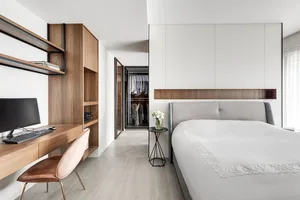 A minimalist bedroom with wooden furniture and a clean, modern design.