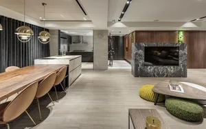 A luxurious modern living room with marble accents, wood furniture, and plush leather seating.