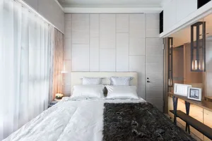 A minimalist bedroom featuring textured paneling and belgian linen.