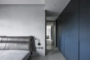 Modern bedroom featuring concrete and metal materials.