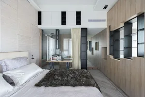 A modern bedroom featuring wood paneling and a cozy fur blanket on the bed. The room has large windows allowing for ample nat