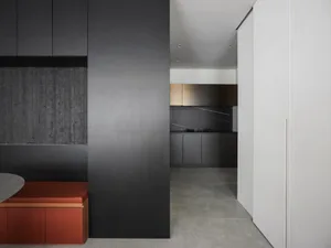 Contemporary kitchen featuring black cabinets, countertops, and a black backsplash.