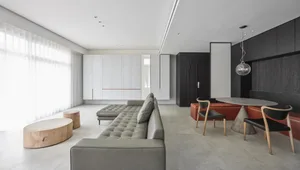 Modern interior design featuring a concrete floor, minimalist furniture, and a contemporary aesthetic.