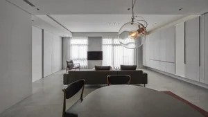 Modern living room with concrete floors and a minimalist design.