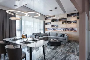 Modern living room with marble floor and grey sofa.