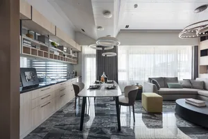 A modern living room featuring marble flooring and walls, with a comfortable sofa and dining table setup.