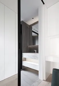 Modern bathroom features marble countertops and concrete walls for a sleek, contemporary design.