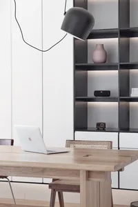 A modern home office with a wooden desk, minimalist design, and metal accents.