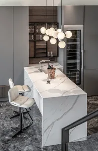 A modern kitchen with marble countertops features a sleek, minimalist design with a focus on functionality and elegance.
