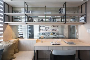 A modern living room with wooden shelves, a sofa, and a desk.