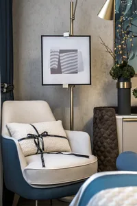 Modern lounge area with textured fabric seating and abstract artwork.