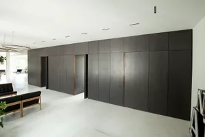 A modern minimalist living room with a concrete floor, clean lines, and sleek design elements.