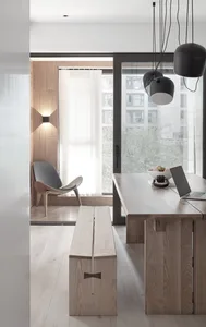 Contemporary living room with minimalist design and wooden furniture and flooring.