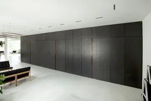 A minimalist office space featuring concrete and metal materials.