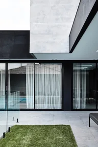 A sleek, modern exterior featuring glass and concrete materials.
