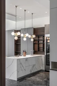 Modern residential kitchen featuring a marble countertop and sleek, contemporary design elements.