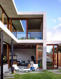 A modern residential home featuring concrete and glass materials.