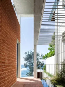 A modern building with a concrete exterior featuring a skylight and water feature.