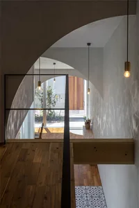 Modern entryway featuring concrete and wooden floors, minimalist design.