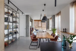 A modern living space featuring concrete and wooden elements.