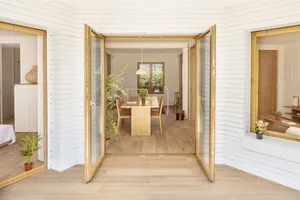 Minimalist dining room with wooden furniture and plants