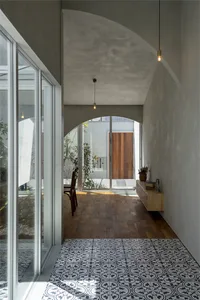 Modern minimalist walkway featuring polished concrete, cement tiles, and wooden elements.