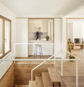 Minimalist residential kitchen featuring wood flooring and minimalist cabinetry.
